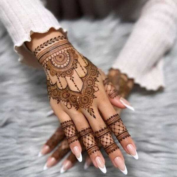 A delicate mandala-inspired henna tattoo that highlights the graceful and artistic beauty of the hands