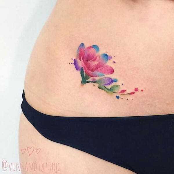 Abstract and watercolor hip tattoo